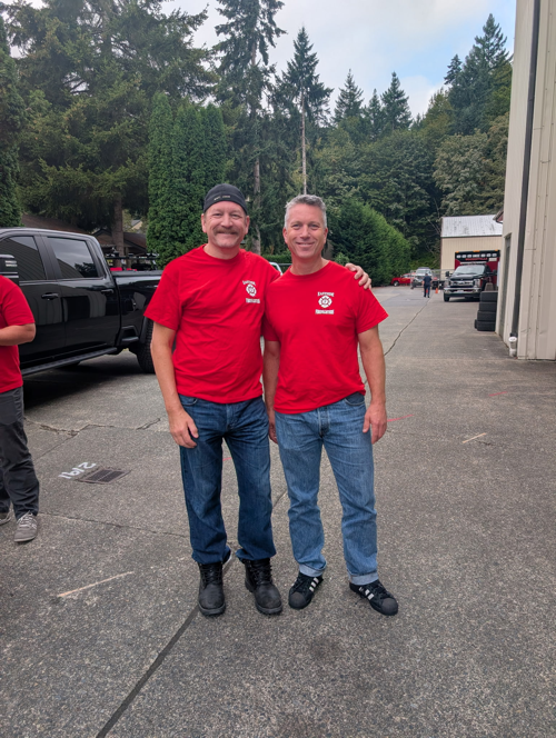 Ray Austin standing with two firefighters