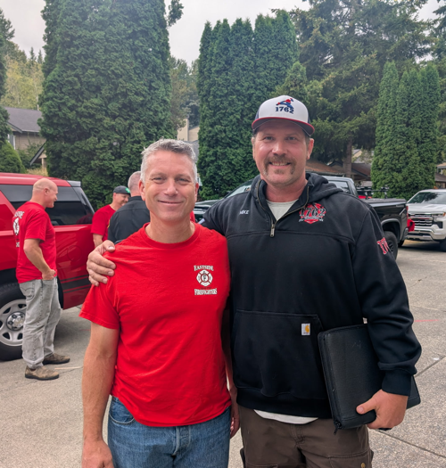 Ray Austin standing beside a man wearing an IAFF Local 1762 jacket